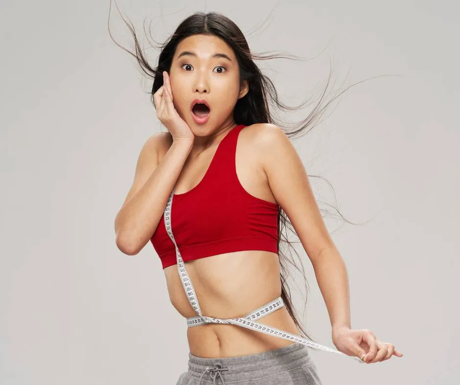 Woman celebrating her body sculpting results